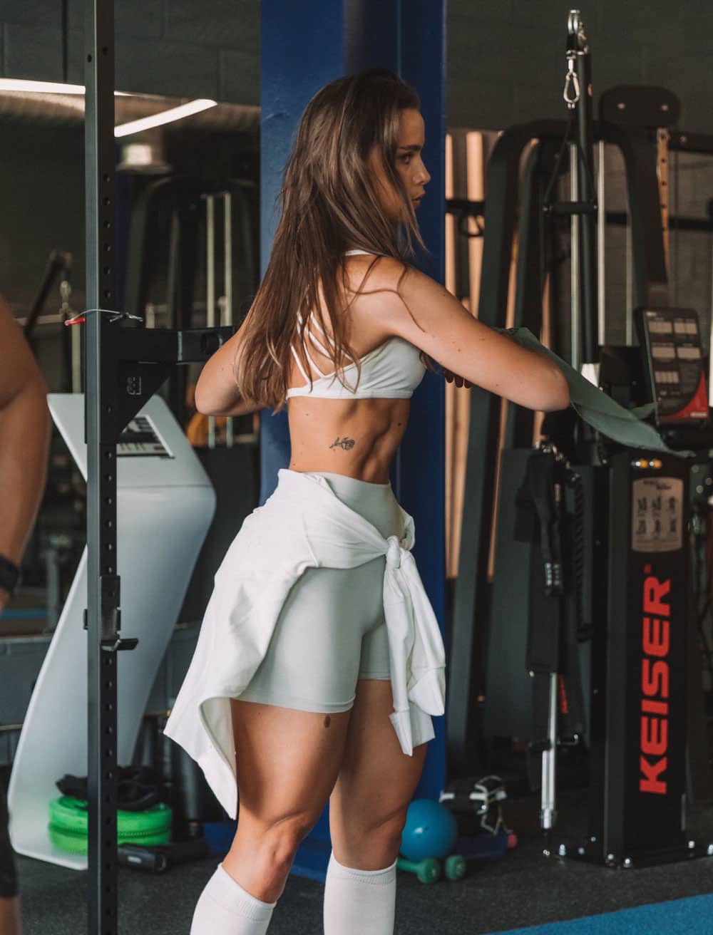 Coach Sofia in the gym twisting her upper body
